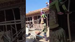 Lifting process of red tiles on villa roof