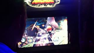 Me playing guitar hero in an arcade