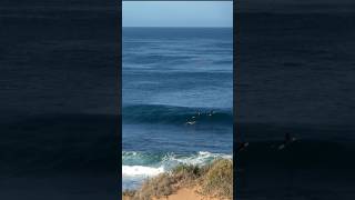 Third surfer in line swoops and scores