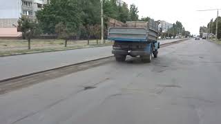 A GAZ flatbed truck overtook a trolley bus. He is in a hurry somewhere. Cherkasy Ukraine Soviet car