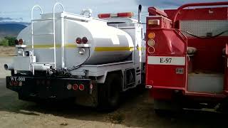 Forest Service water tender painted white from LA area & ex-CDF&FP model 5 fire engine w/ local FD.