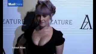 Kelly Osbourne shows off her hourglass figure in a VERY low cut