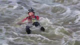 Watch as a firefighter gets swept away by a wall of water at Yalding Weir