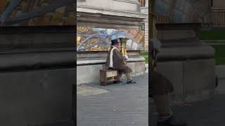 Man playing music using tuba with fire #london #naturalhistorymuseum #street #tuba #fire #music