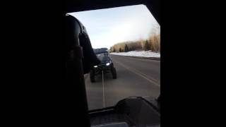 Arctic cat wildcat 1000 towing a 4 seater rzr 800