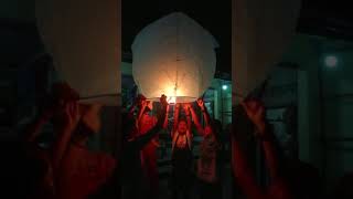 Children lighting a floating Lantern in Pak Beng, Laos