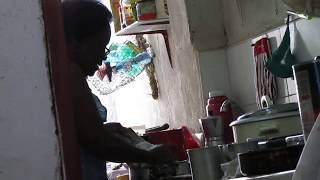 A Singing Cook Melania Tunes Her Cuban Melody While Grating Cuban Malanga In Santiago de Cuba