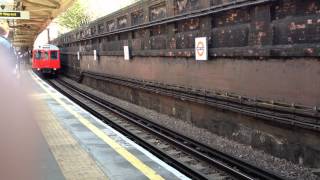 London underground train ariving at Barrons Court station