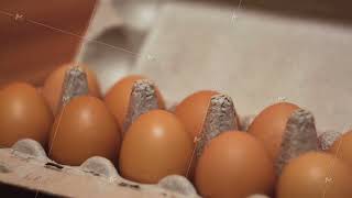 Eggs in a cardboard box on wooden table background. Concept. Close up of fresh carton of chicken