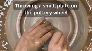 Throwing a small plate on the pottery wheel