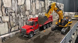 Rc 4ever... Huina 1580 Excavator moving dirt with the Diecast Masters 49 Western Star hauling