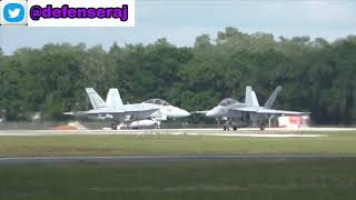 Two f/a 18 super hornet take off by base.