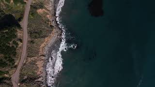 Aerial drone overhead view of a car driving on highway 1 near big sur, california FREE STOCK VIDEO