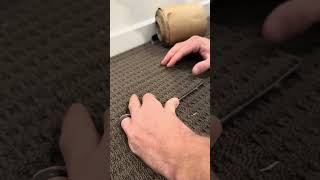 Flooring technician is replacing a burnt spot in the carpet!