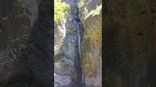 canyoning, little girl comes down from the waterfall