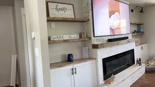 Renovation update Renovation update: Built in wall unit with storage, fireplace, and TV.