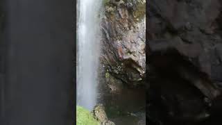 Hidden wales waterfall leads into a cave