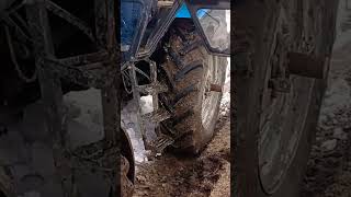 Tractor helps a small tractor stuck in the snow in Belarus