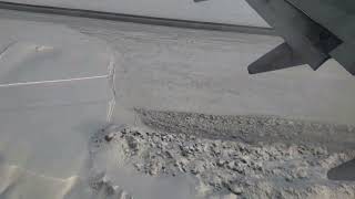 Winter Flight over Icy Alaska and plane landing at Anchorage Airport