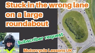 Changing lanes on large roundabouts: what if we get stuck in the wrong lane?