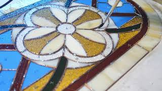 Brush application of flux before soldering the stained-glass window. Artist's hands. Stained glass