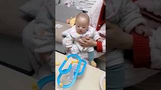 Mom pulls the shirt from Baby