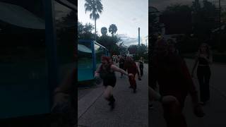 Girl chased and stalked by a zombie at Howl O Scream Tampa 2023