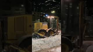 Grader pushing snow banks