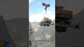 The process of lifting various large transport machines for hydropower station construction.