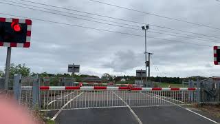 East Coast Main Line Azuma Train passing by a level crossing in Northumberland.