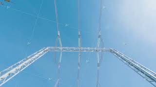 Power poles on background of blue sky. Action. Beautiful electric poles on blue sky background