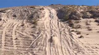 Traxxas Slash 4x with sand paddles climbs the big hill out at Apex