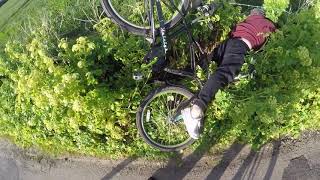 man on bike falls in hedge