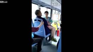 woman sits on mans laps after losing fight over seat on bus