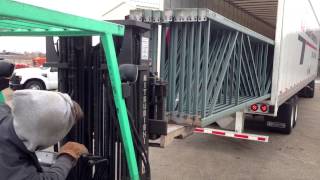 Loading pallet rack uprights into a box truck without a dock