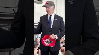 Joe Biden wears Trump hat and tells crowd not to eat dogs and cats