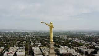 Aerial footage of Los Angeles California Temple, Golden Statue, Santa Monica Blvd