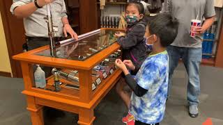 Ryan waiting patiently to check out a lightsaber at the Star Wars store in Disney Springs