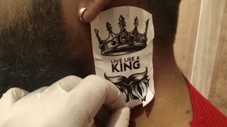 Beard with crown tattoo.