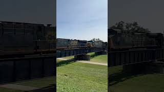 2 locomotives crossing over long bridge.