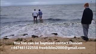 Baptism in the sea of Portuguese man at Southend-on-sea UK in high winds