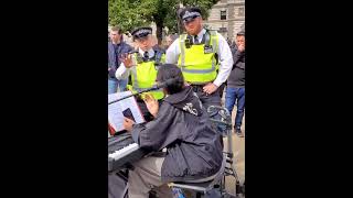 Police stop girl sing Queen of son. outside Westminster hall