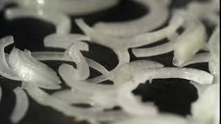 CLOSE-UP View of onion ring being fried   SATISFYING!!!