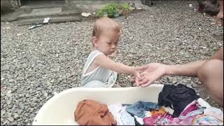 baby is helping washing clothes