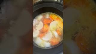 homemade pork ribs soup with radishes and carrots for dinner