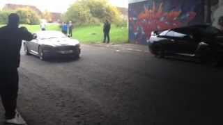 Aston Martin DBS blasting through graffiti tunnel