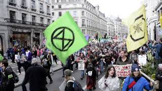 Extinction Rebellion marching down Regent Street in London, UK