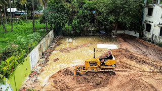 Clearing the water in the house fence to build a new house by truck and dozer in processing work