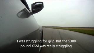 BMW X6M vs Nissan 350Z on wet racetrack