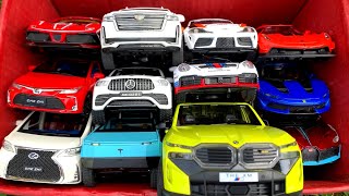 Box Full of Model Cars /BMW XM, Porsche 911, Toyota Supra, Bugatti Divo, Koenigsegg Agera Rs, Tesla